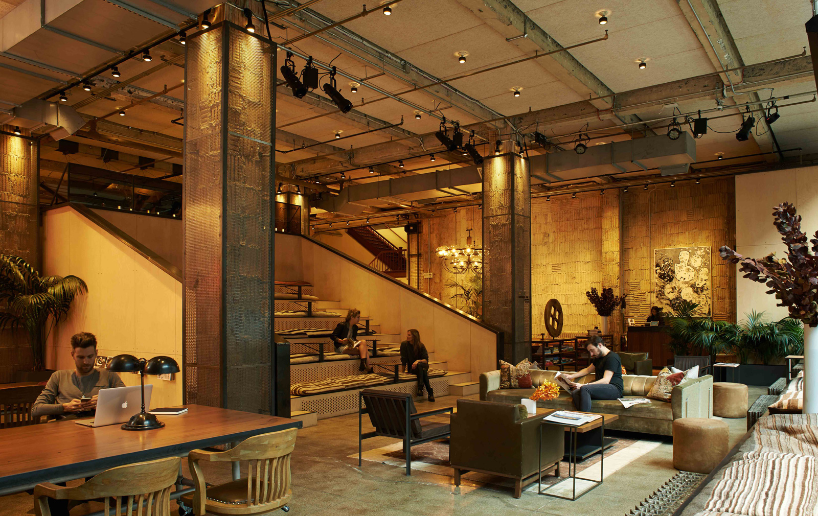 Professionals working inside a design-led coworking lounge